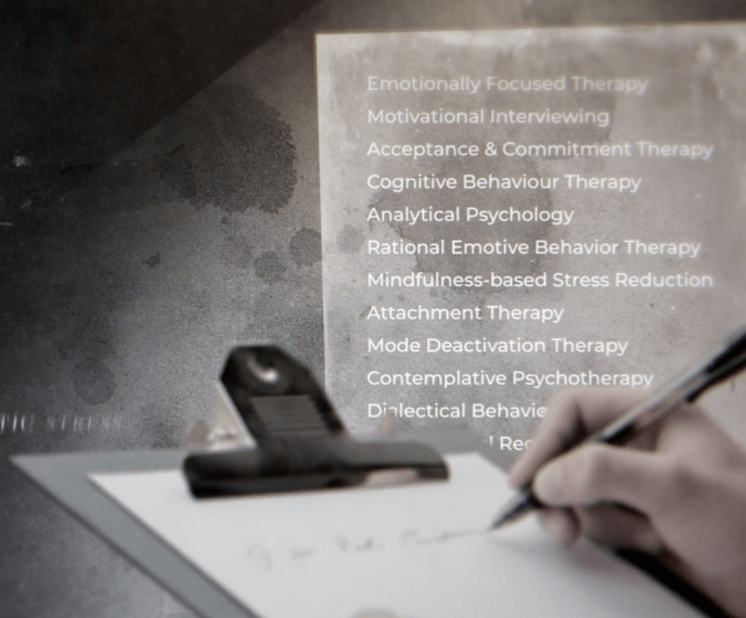 hand holding a pencil at a clipboard with a list in the background