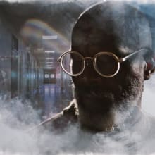 man with glasses in a blurry background
