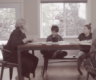 Group talking around a table with Marsha Linehan