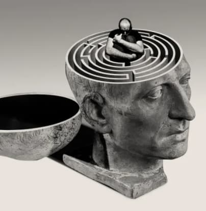A statue of an open head with a maze for a brain.