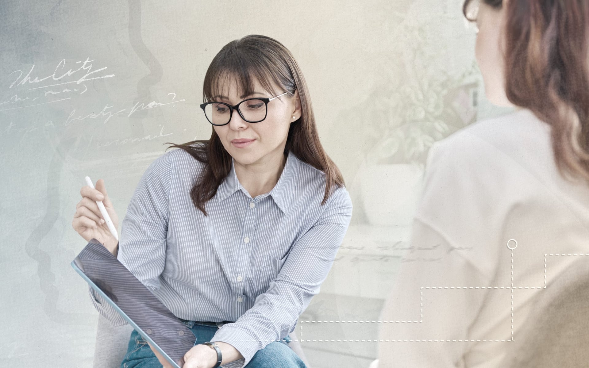 A woman with glasses holding a stylus is sitting and looking at a tablet, practicing Solution Focused Therapy. She is wearing a light blue striped shirt and has long hair. Another person, partially visible, is seated across from her. The background featur