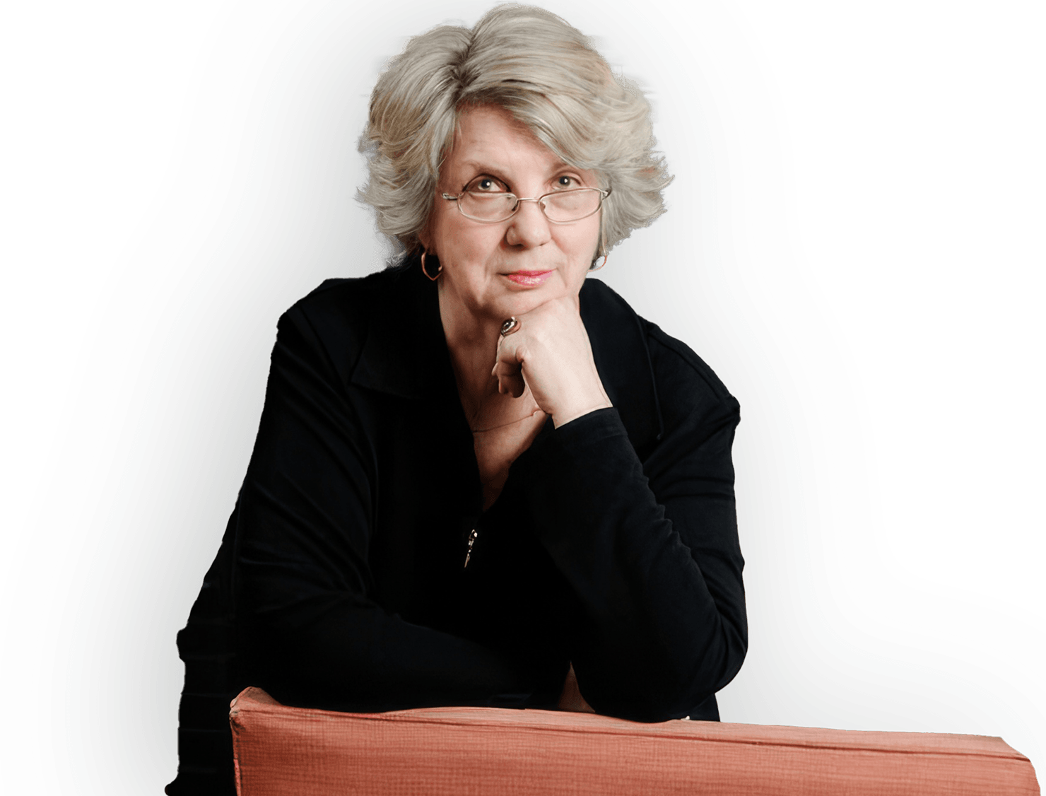 Marsha Linehan, wearing a black top and resting her chin on her hand with a thoughtful expression.