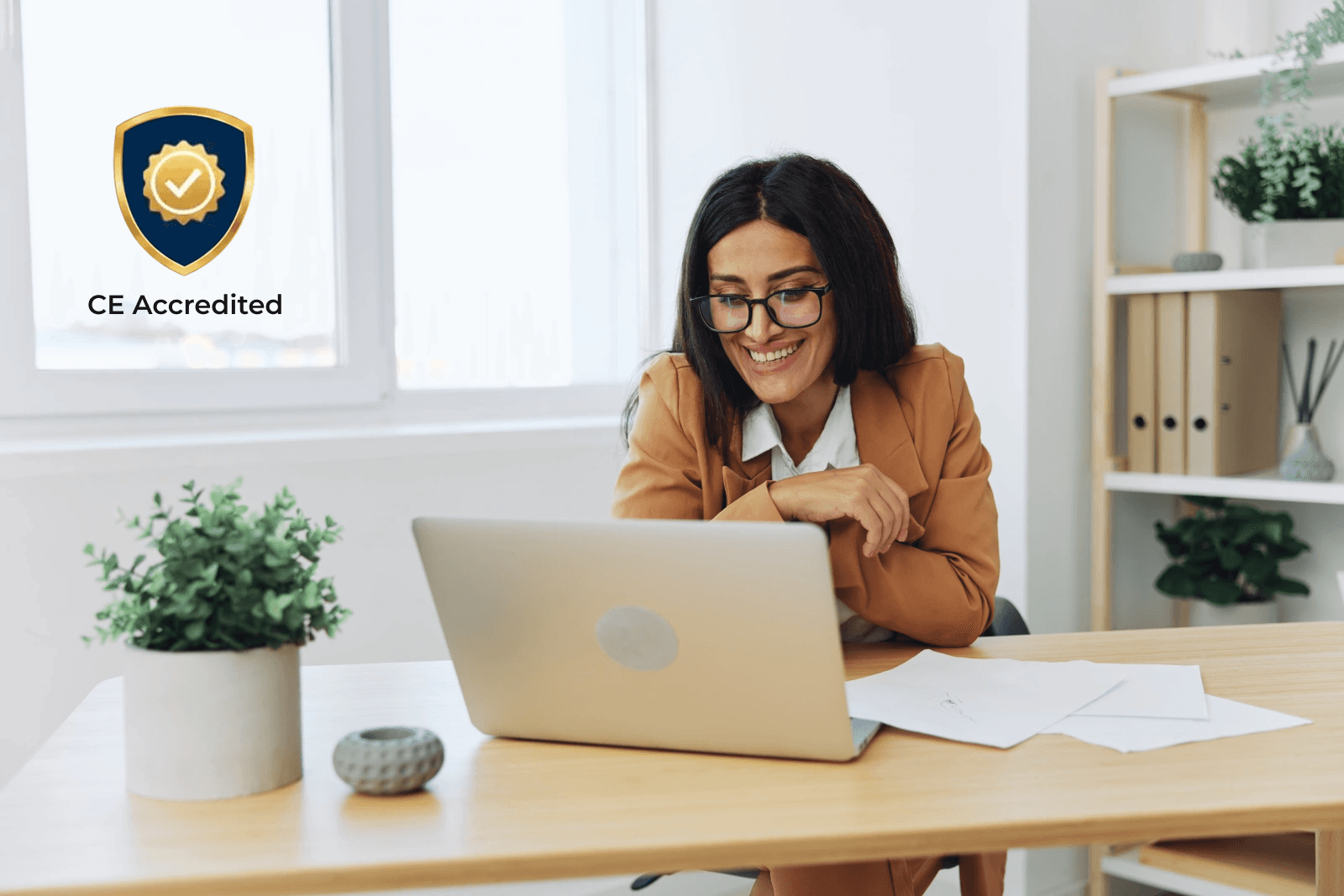 Woman at computer with CE Accreditation badge