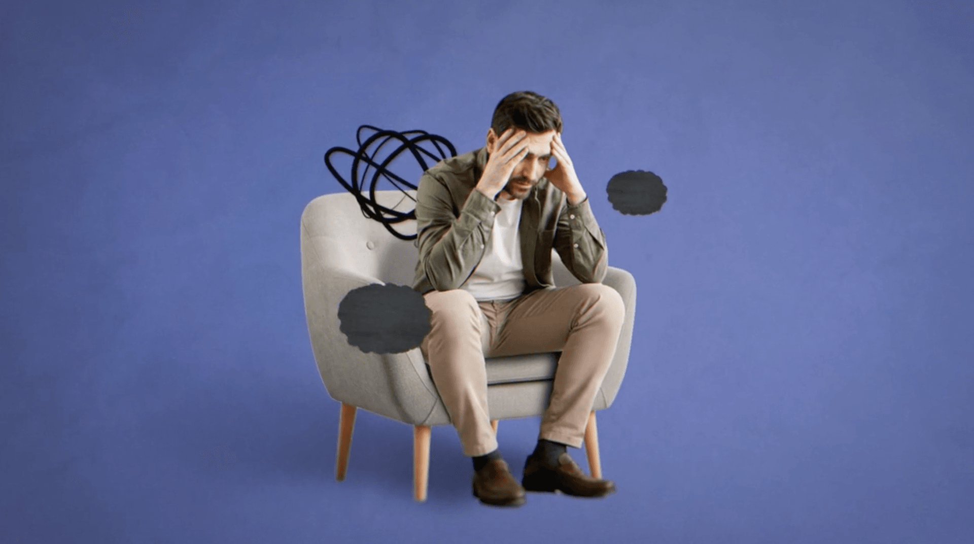 man sitting in chair with clouds and squiggles around his head